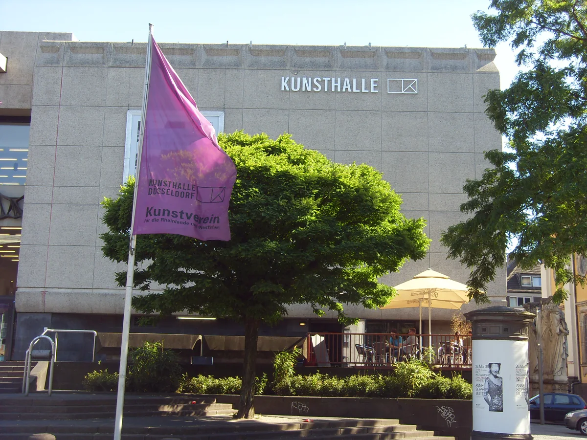 Kunsthalle Düsseldorf am Grabbeplatz mit violetter Fahne und Bäumen vor dem Gebäude